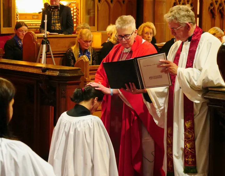 Ordination of Margaret. Bishop Julie lays her hands on Margaret's head.