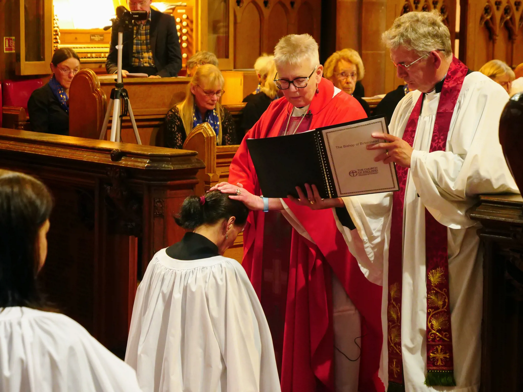 Ordination of Margaret. Bishop Julie lays her hands on Margaret's head.