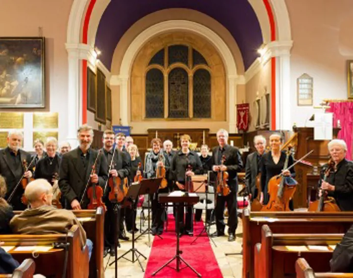 Vale Royal Springs Group in church facing audience with instruments in hand