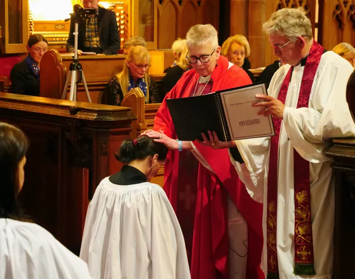 Bishop Julie lays her hands on Margaret during her ordination